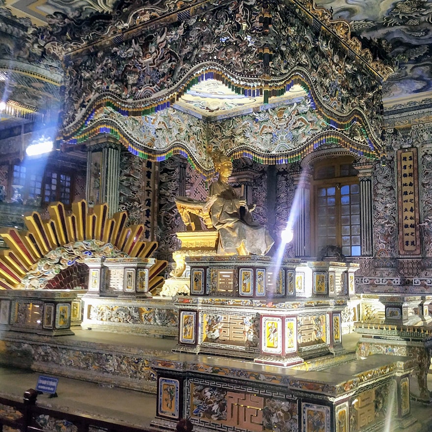 A sub-par amateur photograph of the Khai Dinh gilded bronze statue that sits above his resting place.